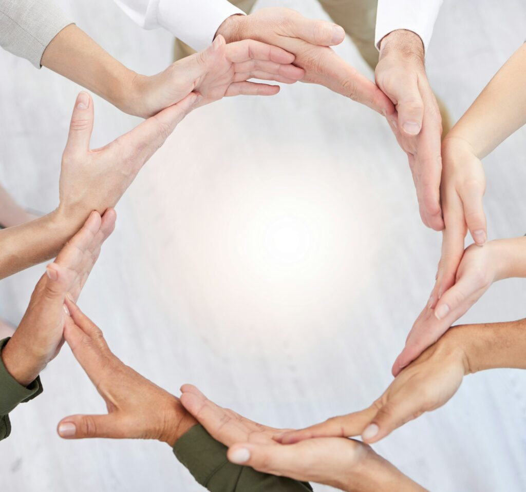 Shot of a group of business people with their hands together in a circle